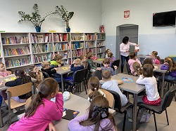 uczniowie w czasi elekcji bibliotecznej siedzą i słuchają nauczycielki