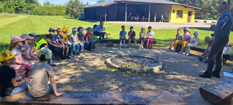 na zdjęciu duża grupa dzieci siedzi w kole pozując do zdjęcia